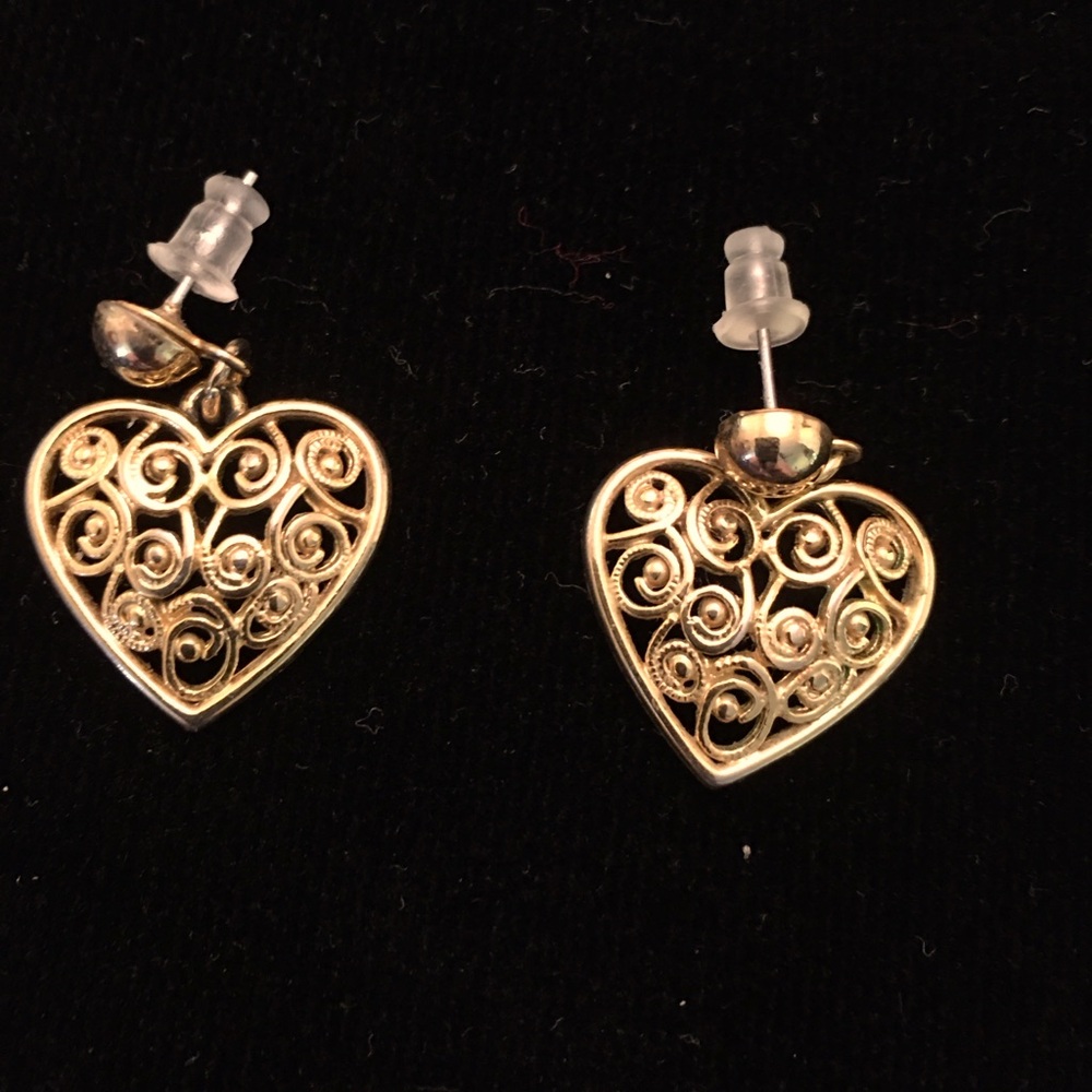 Heart shaped gold tone dangle pierced earrings.